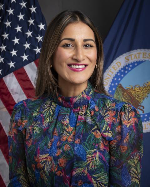 Sanah Baig standing in front of the American and USDA flag.